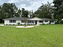 Charming, updated ranch-style home with a well-manicured lawn and stone walkway at 2933 Stearns Rd, Valrico, FL 33596