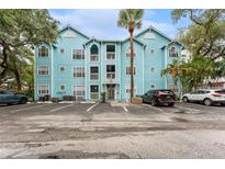 Charming three-story building with a light blue exterior and well-maintained parking lot at 3002 W Cleveland St # D4, Tampa, FL 33609