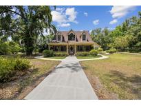 Charming two-story home with a welcoming front porch and well-manicured landscaping, showcasing curb appeal at 3018 Pemberton Trace Ct, Plant City, FL 33565