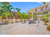 Beautiful patio with brick pavers, lush palm trees, and outdoor seating area at 340 1St N St # I, St Petersburg, FL 33701