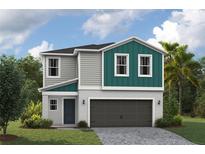 Charming two-story home with gray siding, teal accents, and a two-car garage on a lush green lawn at 37147 Sagemoor Dr, Zephyrhills, FL 33541