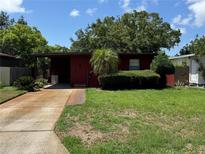 Charming single-story home featuring a well-manicured front lawn and covered driveway at 4136 12Th N Ave, St Petersburg, FL 33713