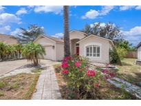 Charming single-story home featuring a well-manicured lawn and vibrant bougainvillea bushes at 4514 Arizona Sun Ct, Valrico, FL 33594