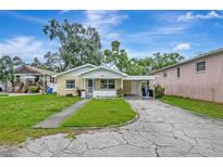 Charming single-story home with a carport, front porch, and a well-maintained lawn at 963 27Th S Ave, St Petersburg, FL 33705