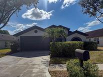 Charming single-story home featuring a well-maintained lawn and a two-car garage at 1716 Bondurant Way, Brandon, FL 33511