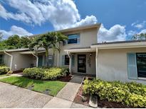 Home exterior featuring manicured landscaping, a covered front entry, and light blue shutters at 2131 Ridge S Rd # 76, Largo, FL 33778
