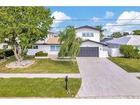 Beautiful two-story home featuring a well-maintained lawn and a spacious two-car garage at 234 Palm Sw Is, Clearwater Beach, FL 33767