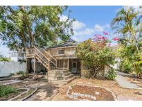 Charming two-story home with a wooden deck and lush landscaping at 3320 Jackson N St, St Petersburg, FL 33704