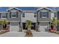Charming townhomes with two-car garages, stone accents and manicured landscaping create curb appeal at 4444 Aqua Mirage St, Sarasota, FL 34238