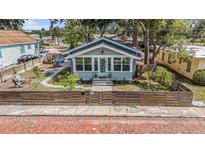 Charming single-story home featuring a quaint front porch, fenced yard, and well-maintained landscaping at 504 Cleveland Ave, Largo, FL 33770