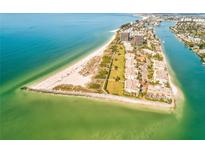 Stunning aerial view of a coastal community with pristine beaches and clear blue waters at 7564 Bayshore Dr # 202, Treasure Island, FL 33706