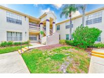 Inviting exterior of a condo complex with well-maintained landscaping and a charming, covered entrance at 7823 Hardwick Dr # 224, New Port Richey, FL 34653