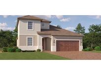 Charming two-story home showcasing a well-manicured lawn and a welcoming, arched entryway at 9779 Minnow Ray Dr, Land O Lakes, FL 34638