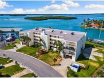 Waterfront condo building with lush landscaping and bay views from private balconies at 12525 3Rd E St # 303, Treasure Island, FL 33706