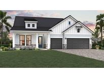 Charming two-story home featuring a two-car garage, landscaped front yard and a stone-accented facade at 18033 Foxtail Loop, Venice, FL 34293