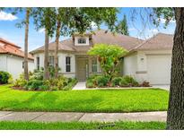 Charming single-story home boasts lush landscaping, manicured lawn, and inviting curb appeal at 2238 Shirecrest Cove Way, Lutz, FL 33558