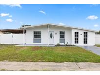 Charming single-story home showcasing a well-maintained lawn and inviting entrance at 2408 Wishing Well Way, Tampa, FL 33619