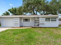 Charming single-story home with a well-maintained lawn and attached garage at 2432 Keene Park Dr, Largo, FL 33771