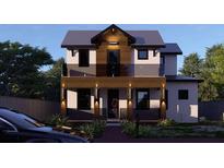 Modern two-story home with a wood and stucco facade, complemented by a glass-paneled balcony at 2501 Quincy S St, St Petersburg, FL 33711