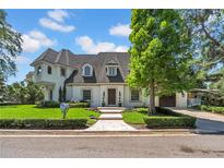 Elegant two-story home with lush lawn, manicured hedges, and brick walkway at 3144 W Waverly Park, Tampa, FL 33629