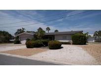 Charming single-story home with manicured hedges, shrubbery and a gravel yard at 6405 2Nd Palm Pt, St Pete Beach, FL 33706