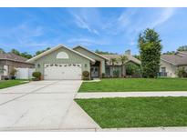 Charming single-story home with a well-manicured lawn, mature landscaping, and a two-car garage at 8549 Pinafore Dr, New Port Richey, FL 34653