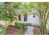 Charming front entrance with lush landscaping, bamboo, and a cozy, inviting doorway to this home at 962 Sombra St, Tampa, FL 33619