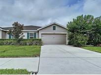 Charming one-story home with a well-manicured lawn and a two-car garage at 10347 Heron Hideaway Loop, Land O Lakes, FL 34638