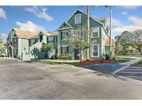 Attractive condo building featuring well-maintained landscaping and convenient parking at 10412 White Lake Ct, Tampa, FL 33626