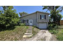 Two-story home featuring a quaint entryway and attached one car garage at 1107 Goshen Rd, Tarpon Springs, FL 34689