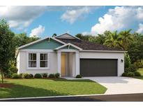 Charming single-story home featuring a two-car garage, beautifully landscaped yard, and covered entry at 12176 Cattleside Dr, Riverview, FL 33579