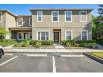 Inviting townhouse exterior features a well-maintained lawn and convenient parking at 31215 Flannery Ct, Wesley Chapel, FL 33543