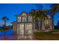 Stunning two-story coastal home boasts a three-car garage and a charming second-floor balcony at 3397 Bluefish Dr, Hernando Beach, FL 34607