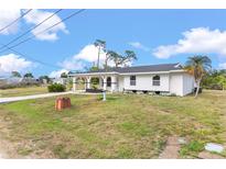 Charming single-story home featuring a covered entry, fresh white paint, and a bright, inviting atmosphere at 3552 Middletown St, Port Charlotte, FL 33952