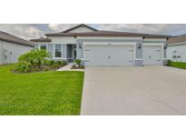 Charming single-story home featuring a three-car garage, lush lawn, and well-manicured landscaping at 3816 N Maryland Ave, Plant City, FL 33565