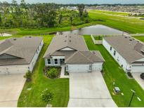 Aerial view of a one-story home with a well-manicured lawn and three car garage at 3816 N Maryland Ave, Plant City, FL 33565