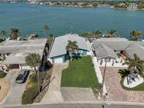 Waterfront home featuring manicured landscaping, a private dock, and stunning water views at 500 20Th Ave, Indian Rocks Beach, FL 33785