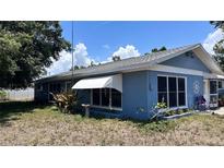 Charming single-story home with a blue exterior, awning-covered window, and partially landscaped yard at 5719 13Th E St, Bradenton, FL 34203