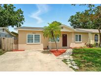 Charming home with a well-maintained lawn and a quaint walkway leading to the front door at 6941 58Th N Way, Pinellas Park, FL 33781