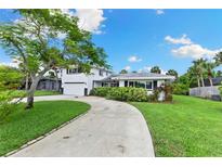 Charming two-story home with a well-maintained lawn and a winding driveway at 996 56Th S Ave, St Petersburg, FL 33705