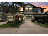 Charming two-story townhome with well-manicured landscaping and a private garage, inviting curb appeal at 11526 Crowned Sparrow Ln, Tampa, FL 33626