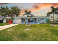 Charming single-story home with a well-manicured lawn and a welcoming front porch at 13978 Barbados Dr, Seminole, FL 33776