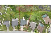 Expansive aerial view of property showing neighborhood, mature trees, and neighboring homes at 1717 Osprey Ln, Lutz, FL 33549