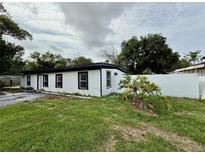 Charming single-story home showcasing its exterior, front lawn, and driveway at 1813 E Wood St, Tampa, FL 33604