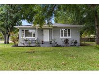 Charming single-story home features a cozy front porch and lush green lawn at 2902 W Lemon St, Tampa, FL 33609