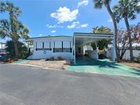 Charming single-story home featuring a carport, well-maintained landscaping, and inviting curb appeal at 4851 W Gandy Blvd # B12L23, Tampa, FL 33611