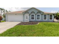 Charming one-story home with well-manicured lawn and a two-car garage, providing a welcoming curb appeal at 4959 Cromey Rd, North Port, FL 34288