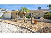 Charming home exterior with a well-maintained yard, rock landscaping, and a quaint decorative sunflower accent at 6503 Santiago Ct, Apollo Beach, FL 33572