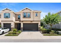 Charming townhome featuring a well-manicured lawn and a convenient two-car garage at 6711 Rocky Park St, Tampa, FL 33625