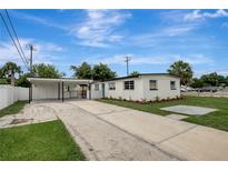 Charming white home with a covered carport and well-maintained landscaping at 7524 Tidewater Trl, Tampa, FL 33619